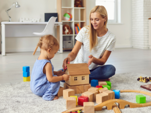A mother playing with a small child.