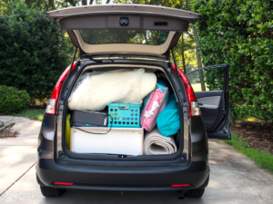 A car trunk full to the brim with college dorm essentials.