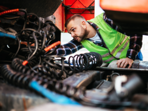 A mechanic doing work on a big rig truck