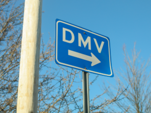 DMV street sign pointing right.