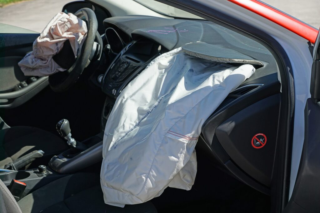 Driver and passenger air bags deployed in a car.
